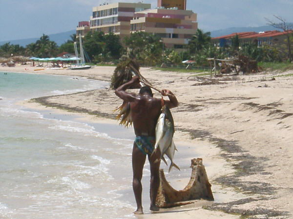 Man with fish at Playa Ancon